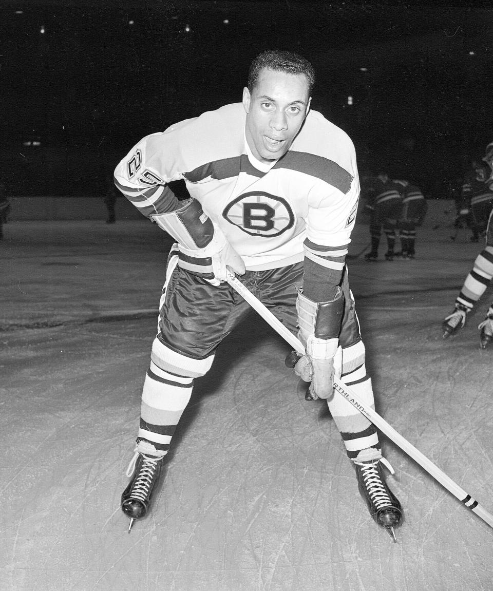 FILE - In this Nov. 23, 1960, file photo, 25-year-old left wing Willie O'Ree, the first black player of the National Hockey League, warms up in his Boston Bruins uniform prior to a game against the New York Rangers at New York's Madison Square Garden. The Boston Bruins say they are retiring the jersey of Willie O’Ree, who broke the NHL’s color barrier. O’Ree will have his jersey honored prior to the Bruins’ Feb. 18 game against the New Jersey Devils. He became the league’s first Black player when he suited up for Boston on Jan. 18, 1958 against the Montreal Canadiens, despite being legally blind in one eye. (AP Photo/File)