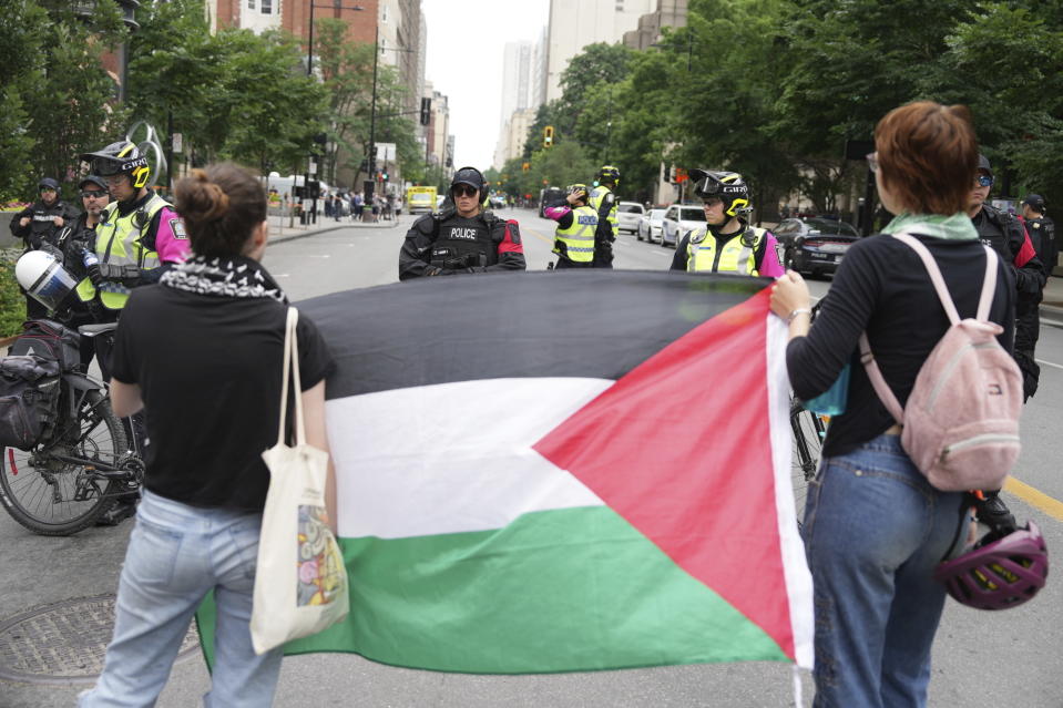 Police block protesters from the campus as security clears the pro-Palestinian encampment at McGill University in Montreal, Wednesday, July 10, 2024. (Christinne Muschi/The Canadian Press via AP)