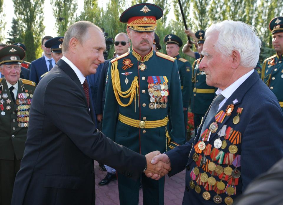 Russian President Vladimir Putin, left, greets a WWII veteran as he arrives to attend a laying ceremony in Kursk, 426 kilometers (266 miles) south of Moscow, Russia, Thursday, Aug. 23, 2018. Putin attends a ceremony marking the 75th anniversary of the battle of Kursk in which the Soviet army routed Nazi troops. It is described by historians as the largest tank battle in history involving thousands of tanks.(Alexei Druzhinin, Sputnik, Kremlin Pool Photo via AP)