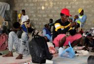 Ethiopian migrants rest before they were flown back to Ethiopia, at an IOM shelter in Aden