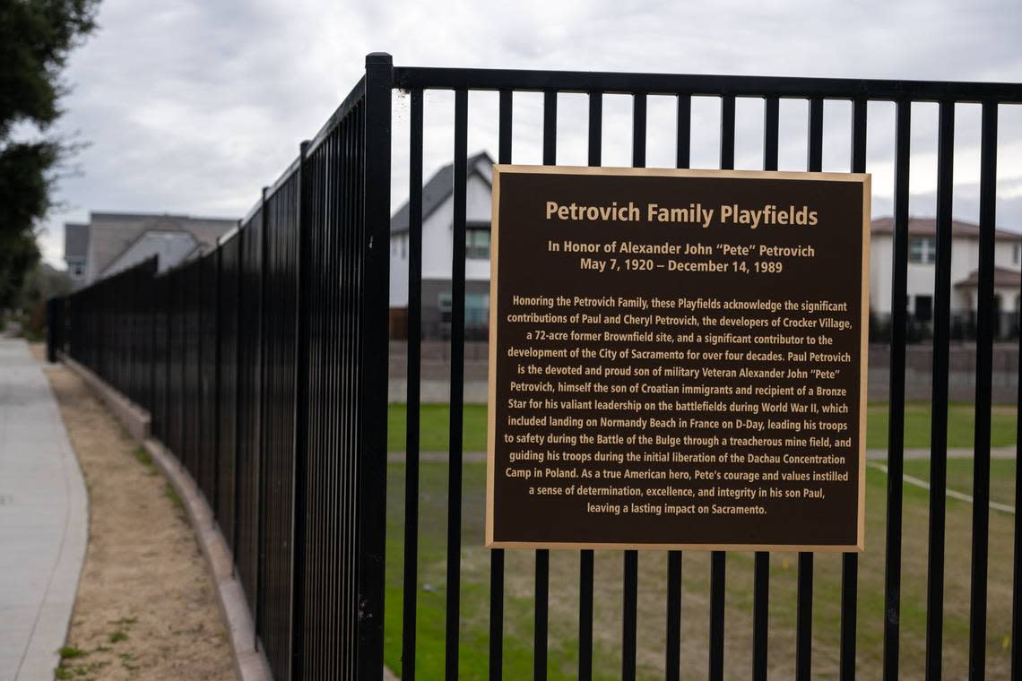 A plaque at Petrovich Family Playfields in Sacramento’s Crocker Village development, shown on Wednesday, Dec. 6, 2023, recounts the family history of developer Paul Petrovich. Paul Kitagaki Jr./pkitagaki@sacbee.com