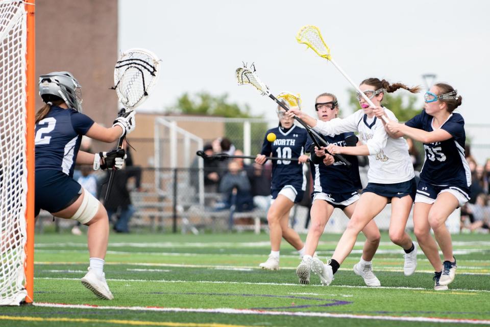 Council Rock South's Amy Loving shoots against Council Rock North goalie Lucy Carney in a girls lacrosse game at Council Rock South in Northampton Township on Wednesday, May 3, 2023. South upended rival North 13-7