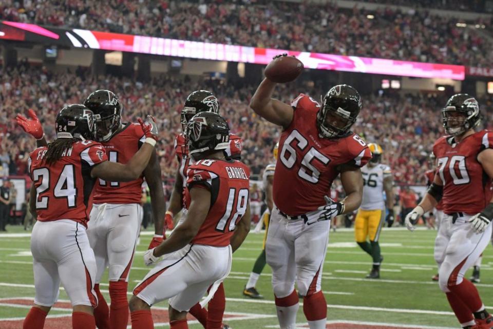Oct 30, 2016; Atlanta, GA, USA; Atlanta Falcons offensive guard Chris Chester (65) spikes the ball after running back Devonta Freeman (24) scored a touchdown against the Green Bay Packers during the second quarter at the Georgia Dome. Mandatory Credit: Dale Zanine-USA TODAY Sports