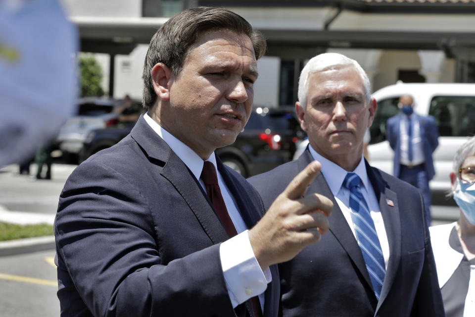 DeSantis, left, speaks to the media in Orlando, Fla., with Vice President Mike Pence in May last year, as part of an initiative to deliver personal protective equipment to more than 15,000 U.S. nursing homes.