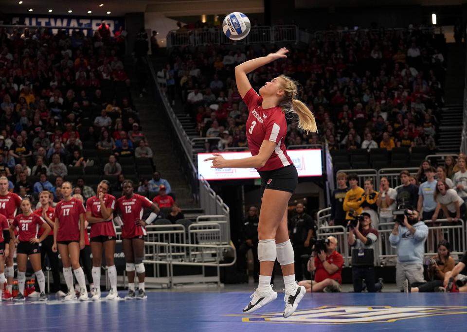 Wisconsin libero Saige Damrow serves during a volleyball match against Marquette on Wednesday at Fiserv Forum. Official attendance was 17,037, making it the largest indoor regular-season crowd for a volleyball match in NCAA history.