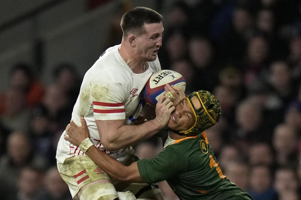 FILE - England's Tom Curry, left, collides with South Africa's Kurt-Lee Arendse during the international rugby match between England and South Africa at Twickenham stadium in London, on Nov. 26, 2022. This Rugby World Cup was always the ultimate goal for the Springboks coaching combination of Rassie Erasmus and Jacques Nienaber, who sat down soon after taking over a struggling team in early 2018 and began plotting a five-year plan to build a squad for France 2023. (AP Photo/Alastair Grant, File)