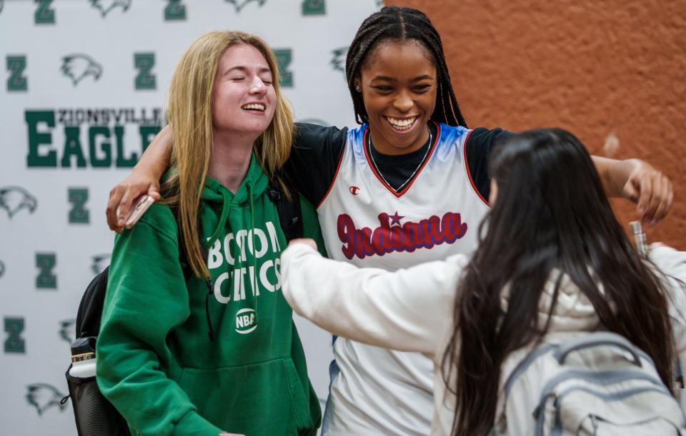 After being named 2023 IndyStar Miss Basketball, Zionsville High School's Laila Hull gets a hug Monday, March 13, 2023, from teammates Allie Caldwell (left) and Faith Leedy Jr.