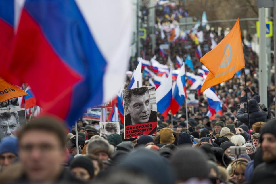 People march in memory of opposition leader Boris Nemtsov, portrait in center, in Moscow, Russia, Sunday, Feb. 26, 2017. Thousands of Russians take to the streets of downtown Moscow to mark two years since Nemtsov was gunned down outside the Kremlin. (AP Photo/Ivan Sekretarev)