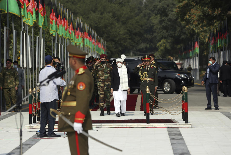 Afghan President Ashraf Ghani, center, arrives during the Independence Day celebrations at the Defense Ministry in Kabul, Afghanistan, Tuesday, Aug. 18, 2020. (AP Photo/Rahmat Gul)