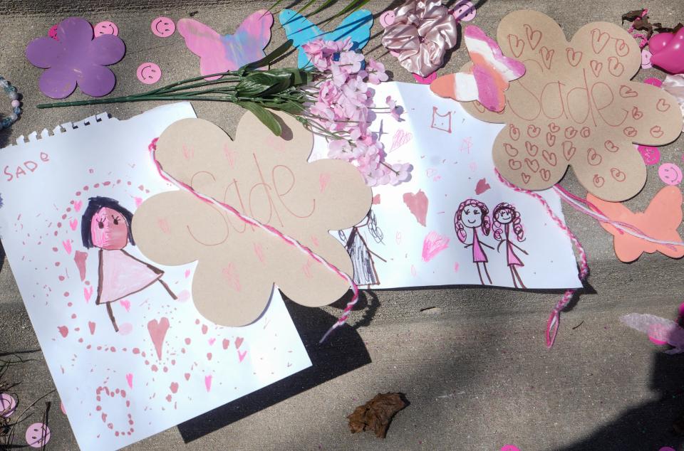 Friends and family of Sade Robinson, along with other community members, decorated the front yard of the home of her accused killer, Maxwell Anderson, in Milwaukee. Pink ribbons have been tied around trees, balloons sway in wind, and cards and posters have been secured on the lawn, with messages to Robinson written in chalk on the sidewalk.