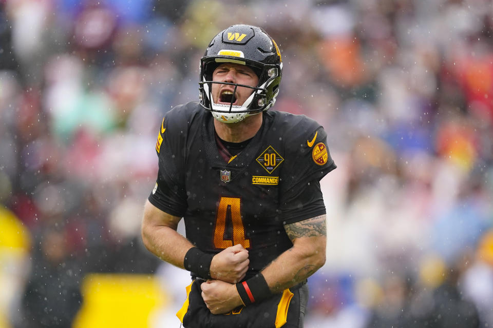 Washington Commanders quarterback Taylor Heinicke (4) yelling as he celebrates a touchdown against the Atlanta Falcons during the first half of an NFL football game, Sunday, Nov. 27, 2022, in Landover, Md. (AP Photo/Patrick Semansky)