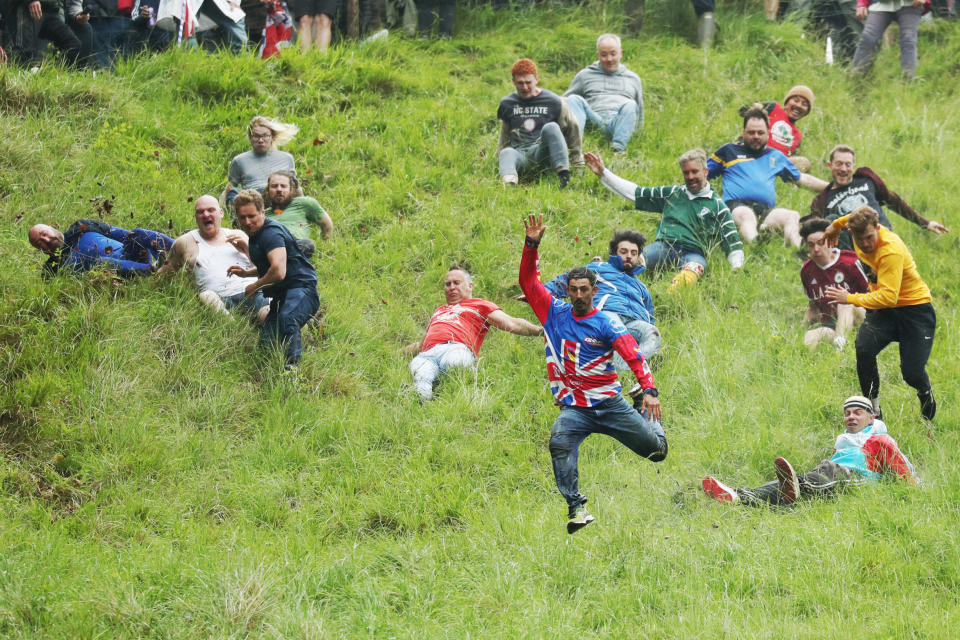 GLOUCESTER, ENGLAND - JUNE 05: Chris Anderson takes part in the man's downhill race on June 05, 2022 in Gloucester, England. The Cooper's Hill Cheese-Rolling and Wake annual event returns this year after a break during the Covid pandemic. It is held on the Spring Bank Holiday at Cooper's Hill, near Gloucester and this year it happens to coincide with the Queen's Platinum Jubilee. Participants race down the 200-yard-long hill after a 3.6kg round of Double Gloucester cheese. (Photo by Cameron Smith/Getty Images)