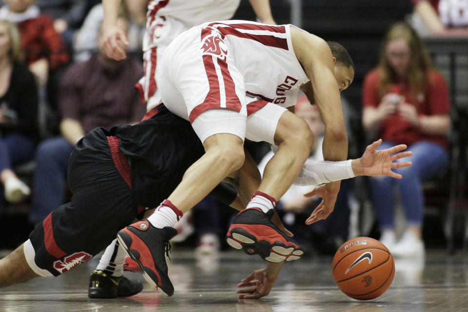 Washington State guard Jervae Robinson, top, and Stanford guard Bryce Wills go after the ball during the second half of an NCAA college basketball game in Pullman, Wash., Sunday, Feb. 23, 2020. Stanford won 75-57. (AP Photo/Young Kwak)