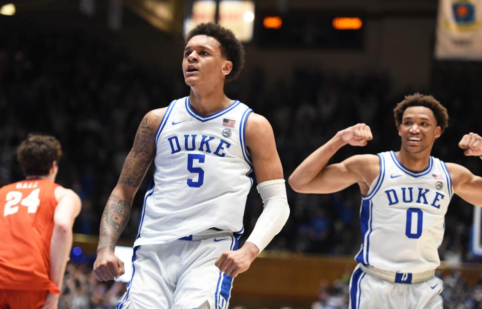 Duke Blue Devils forwards Paolo Banchero (5) and Wendell Moore Jr. (0) react to a basket during the second half against the Clemson Tigers at Cameron Indoor Stadium.