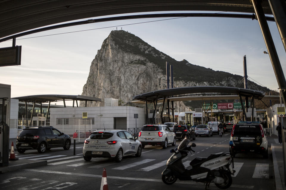 Cars queue to cross the border between Spain and Gibraltar, in La Linea de la Concepcion, Spain, Friday Jan. 31, 2020. Britain officially leaves the European Union on Friday after a debilitating political period that has bitterly divided the nation since the 2016 Brexit referendum. (AP Photo/Javier Fergo)