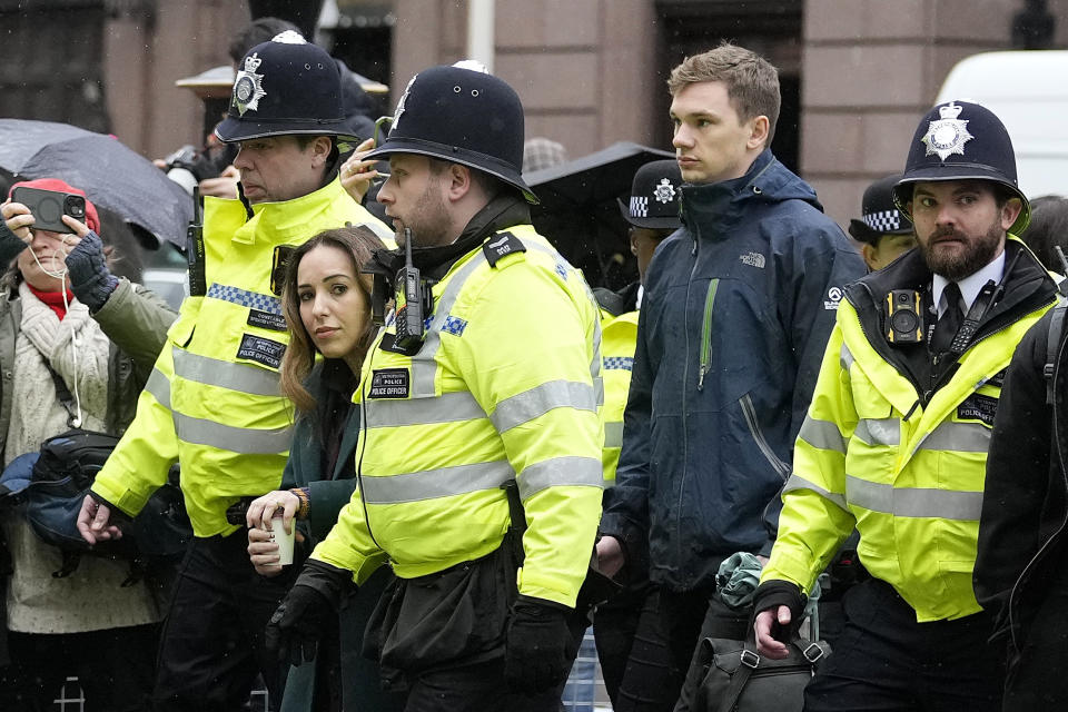 Stella Assange, wife of Julian Assange, is escorted by police as she returns to the Royal Courts of Justice in London, Wednesday, Feb. 21, 2024. Julian Assange's lawyers are on their final U.K. legal challenge to stop the WikiLeaks founder from being sent to the United States to face spying charges. The 52-year-old has been fighting extradition for more than a decade, including seven years in self-exile in the Ecuadorian Embassy in London and the last five years in a high-security prison. (AP Photo/Alastair Grant)