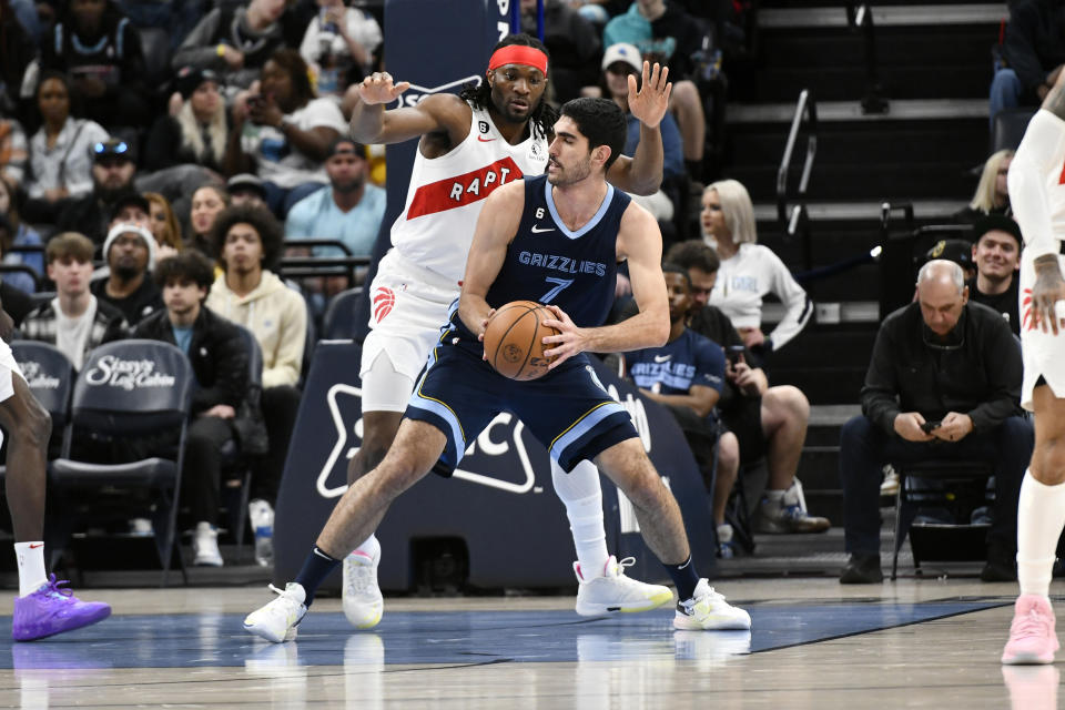 Memphis Grizzlies forward Santi Aldama (7) handles the ball against Toronto Raptors forward Precious Achiuwa in the first half of an NBA basketball game Sunday, Feb. 5, 2023, in Memphis, Tenn. (AP Photo/Brandon Dill)