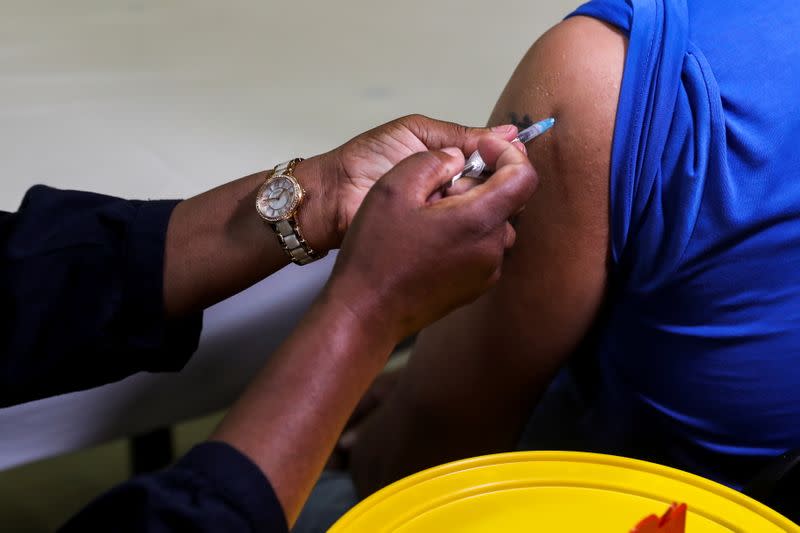 A healthcare worker administers the Pfizer coronavirus disease (COVID-19) vaccine to a man, amidst the spread of the SARS-CoV-2 variant Omicron, in Johannesburg