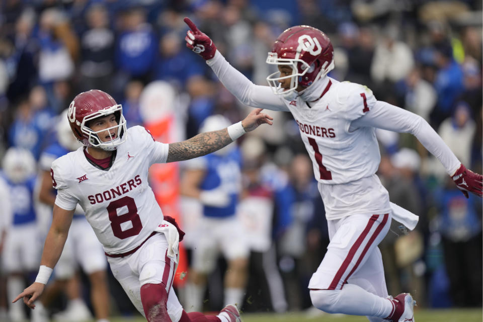 Oklahoma's wide receiver Jayden Gibson (1) celebrates with quarterback Dillon Gabriel (8) after scoring a touchdown against BYU during the first half of an NCAA college football game Saturday, Nov. 18, 2023, in Provo, Utah. (AP Photo/Rick Bowmer)
