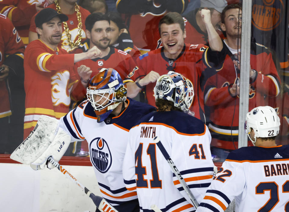 Edmonton Oilers goalie Mike Smith (41) heads to the bench as goalie Mikko Koskinen takes the ice during the first period of Game 1 of an NHL hockey second-round playoff series against the Calgary Flames on Wednesday, May 18, 2022, in Calgary, Alberta. (Jeff McIntosh/The Canadian Press via AP)