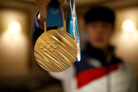 South Korea's Skeleton Gold medalist Yun Sung-bin poses for photographs with his Gold medal during an interview with Reuters in Pyeongchang, South Korea, February 18, 2018. REUTERS/Kim Hong-Ji