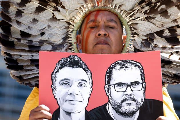 A member of the Articulation of Indigenous Peoples of Brazil (APIB) holds the image of missing British journalist Dom Phillips and Brazilian Indigenous affairs specialist Bruno Pereira during a protest in Europe. Brazil's police confirmed Wednesday that someone had confessed to killing the two men in a remote region of the Amazon rainforest. (Photo: KENZO TRIBOUILLARD via Getty Images)