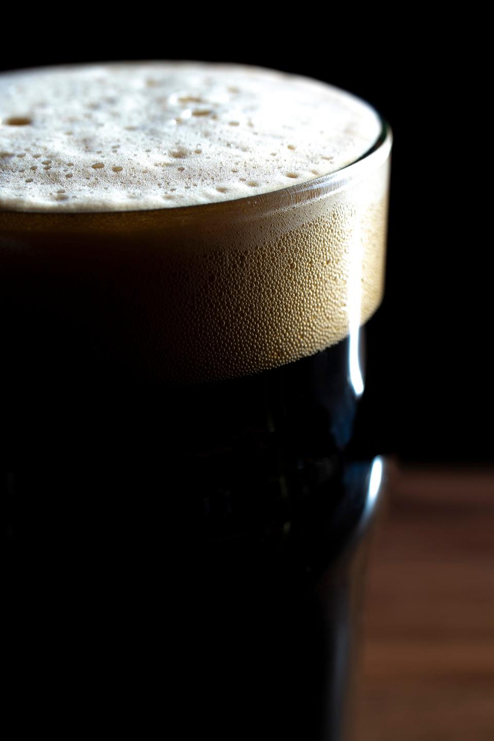 Feb 21, 2023; Columbus, Ohio, United States;  A raspberry chocolate stout head rises to the edge of the glass at Columbus Brewing Company’s newly opened beer hall in Franklin Park. Mandatory Credit: Joseph Scheller-The Columbus Dispatch