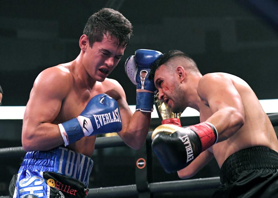 Ashland City’s Tyler Tomlin, left, and Jose Zaragoza compete in the super lightweights match at Bridgestone Arena in Nashville on Saturday, Feb 15, 2020. 