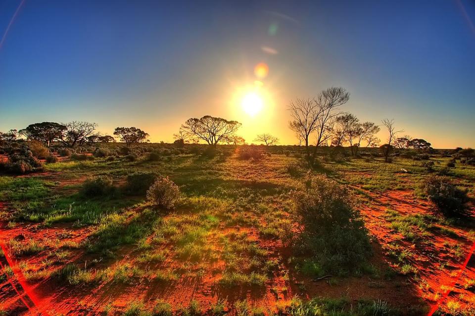 <p>The sunset casts a shadow on the great Australian outback.</p>
