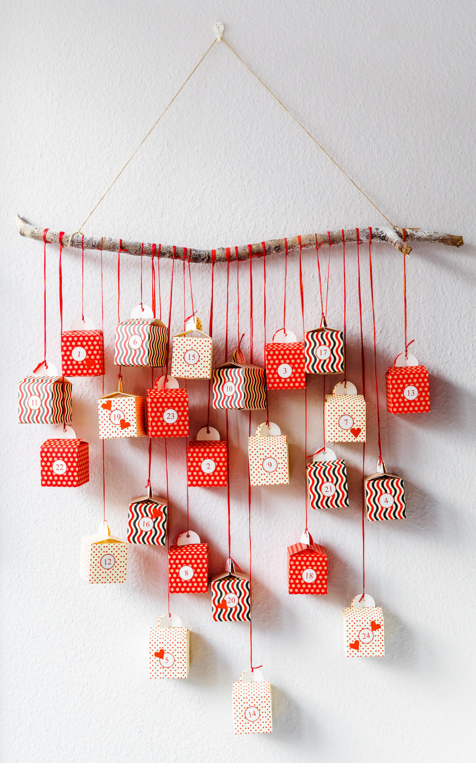 Handmade advent calendar gift boxes hanging on the wall. Sustainable Christmas,  zero waste, plastic free.
