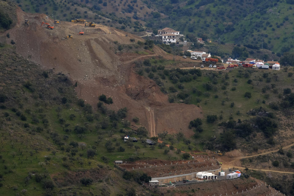 Drill machines and excavating machinery work on top of the mountain, next to a deep borehole to reach a 2-year-old boy trapped there for six days near the town of Totalan in Malaga, Spain, Saturday, Jan. 19, 2019. Authorities in southern Spain say that they hope to reach the spot where they believe the two-year-old boy who fell in a borehole six days ago is trapped in approximately 35 hours. The leading engineer coordinating the search-and-rescue operation says Saturday that the estimate depends on everything "going favorably." (AP Photo/Gregorio Marrero)