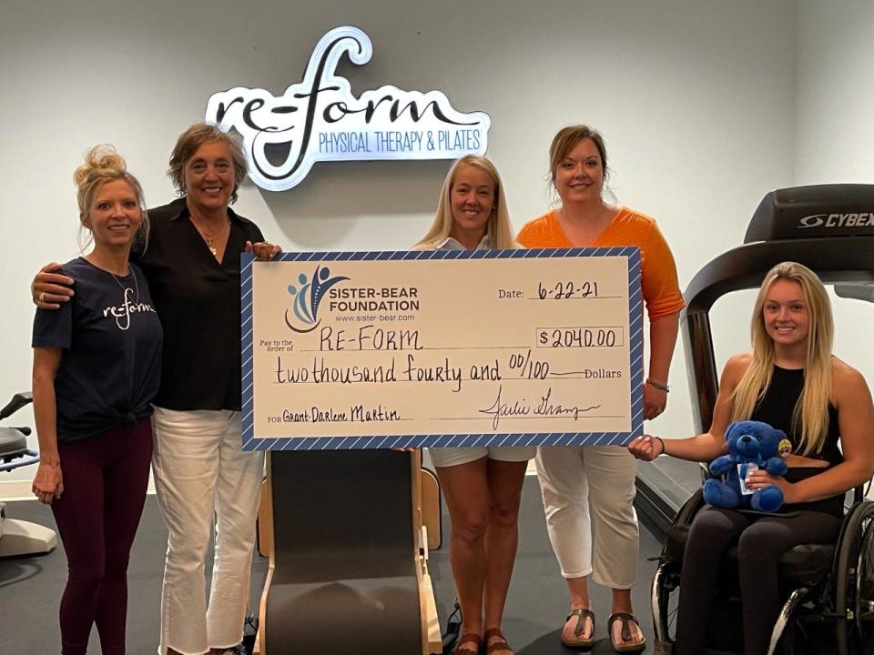 Sister-Bear Foundation surprised Darlene Martin, a retired Amarillo teacher who was born with cerebral palsy, during a therapy session with a check for $2,040 made out to Re-Form Physical Therapy & Pilates, which will pay for 24 therapy sessions that are not covered by her insurance.