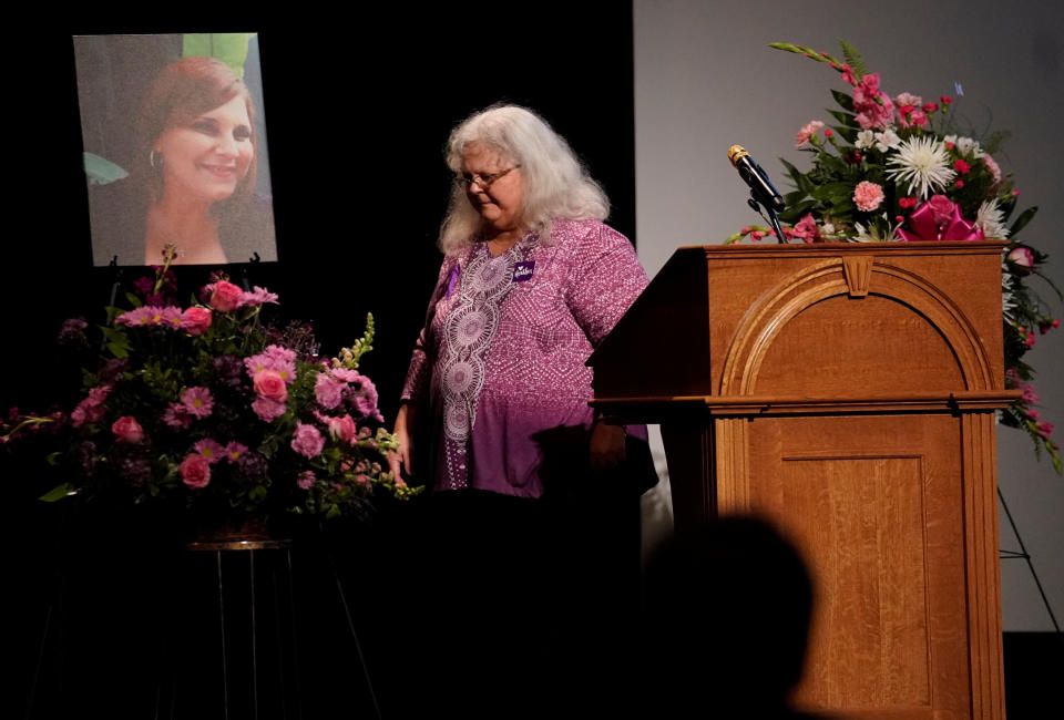 Heather Heyer's mother, Susan Bro, walks by&nbsp;a picture of her daughter after speaking at her memorial service.