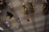 <p>A Jandilla ranch bull is dragged out of the bullring during a bullfight at the San Fermin Fiestas in Pamplona, Spain, July 11, 2017. (Photo: Alvaro Barrientos/AP) </p>