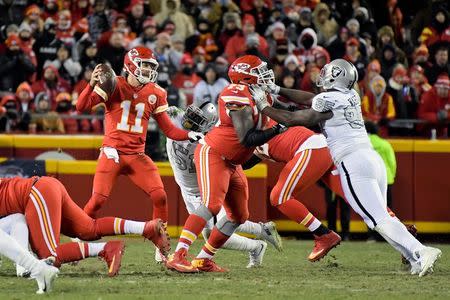 Dec 8, 2016; Kansas City, MO, USA; Kansas City Chiefs quarterback Alex Smith (11) reacts during a NFL football game against Oakland Raiders outside linebacker Bruce Irvin (51) at Arrowhead Stadium. The Chiefs defeated the Raiders 21-13. Mandatory Credit: Kirby Lee-USA TODAY Sports