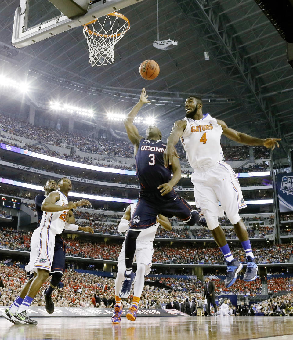 Connecticut guard Terrence Samuel (3) shoots as Florida center Patric Young (4) defends during the first half of the NCAA Final Four tournament college basketball semifinal game Saturday, April 5, 2014, in Arlington, Texas. (AP Photo/David J. Phillip)