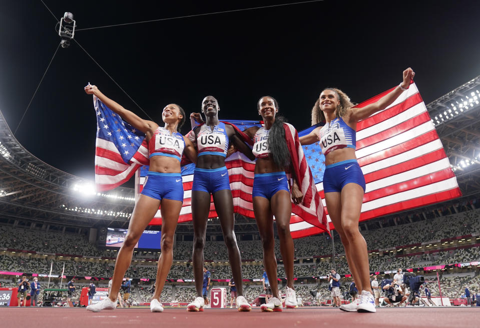 The United States team of Allyson Felix, Athing Mu, Dalilah Muhammad and Sydney Mclaughlin, from left, celebrate winning the gold medal in the final of the women's 4 x 400-meter relay at the 2020 Summer Olympics, Saturday, Aug. 7, 2021, in Tokyo, Japan. (AP Photo/Charlie Riedel)