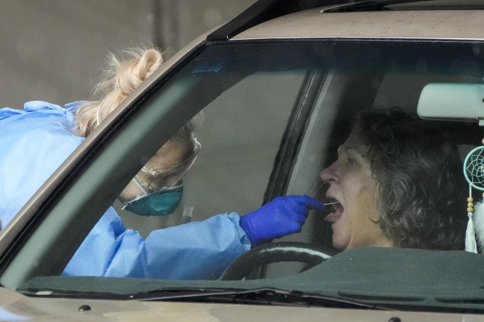 A woman receives a COVID-19 test at a testing station in Nelson Bay, Australia, Monday, June 28, 2021. Australia was battling to contain several COVID-19 clusters around the country on Monday in what some experts have described as the nation’s most dangerous stage of the pandemic since the earliest days. (AP Photo/Mark Baker)