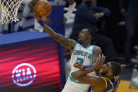 Charlotte Hornets guard Terry Rozier, top, shoots over Golden State Warriors center Kevon Looney during the second half of an NBA basketball game in San Francisco, Friday, Feb. 26, 2021. (AP Photo/Jeff Chiu)