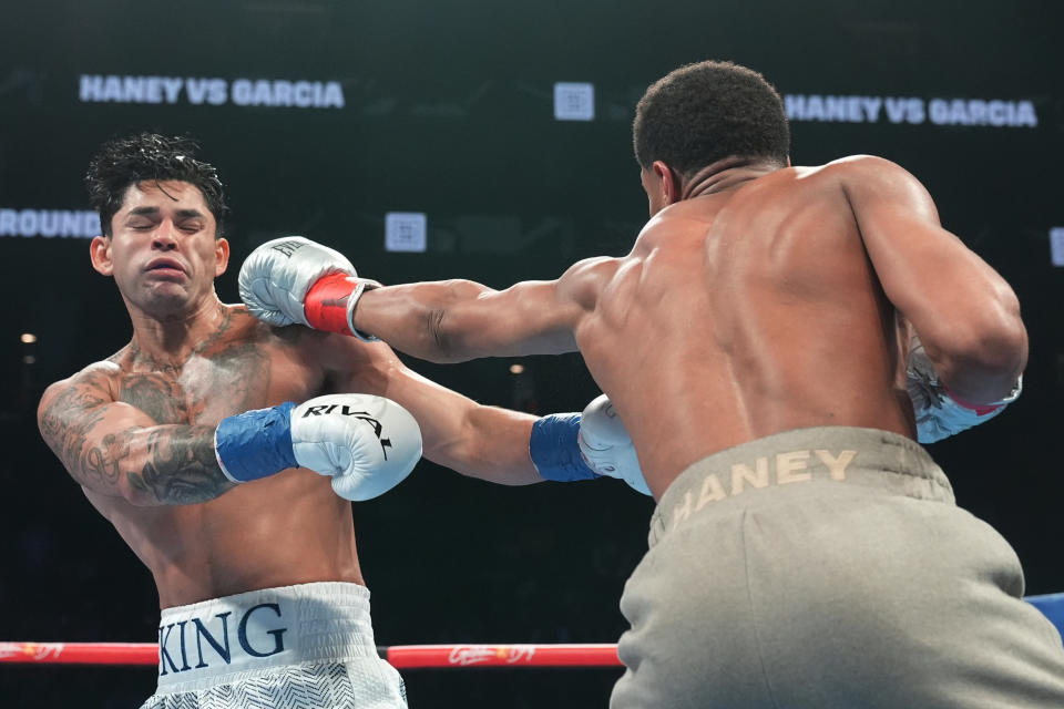 Devin Haney, right, punches Ryan Garcia during the second round of a super lightweight boxing match early Sunday, April 21, 2024, in New York. (AP Photo/Frank Franklin II)