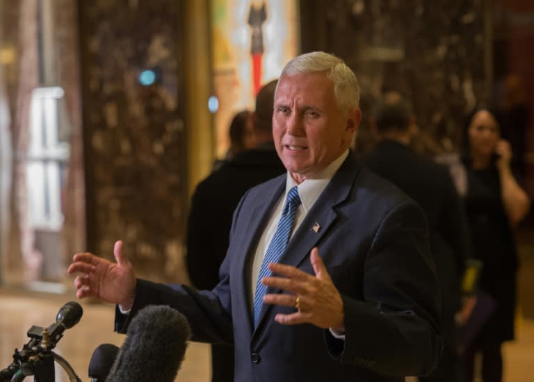 Vice-president-elect Mike Pence speaks with the press as he leaves Trump Tower in New York