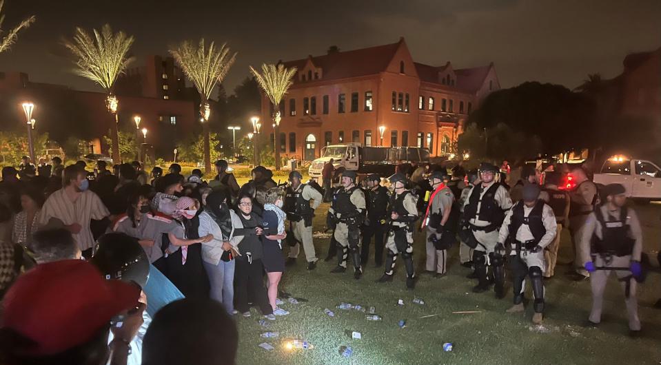 Protesters and law enforcement officers face off on the Alumni Lawn at Arizona State University's Tempe campus on April 27, 2024.