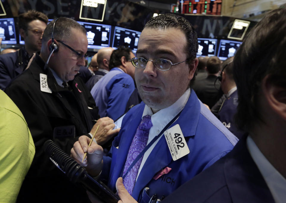 Trader Richard Scardino, right, works on the floor of the New York Stock Exchange, Wednesday, March 26, 2014. The stock market opened higher Wednesday after a strong report on American manufacturing. The maker of the hit game "Candy Crush Saga" flopped in its market debut.(AP Photo/Richard Drew)