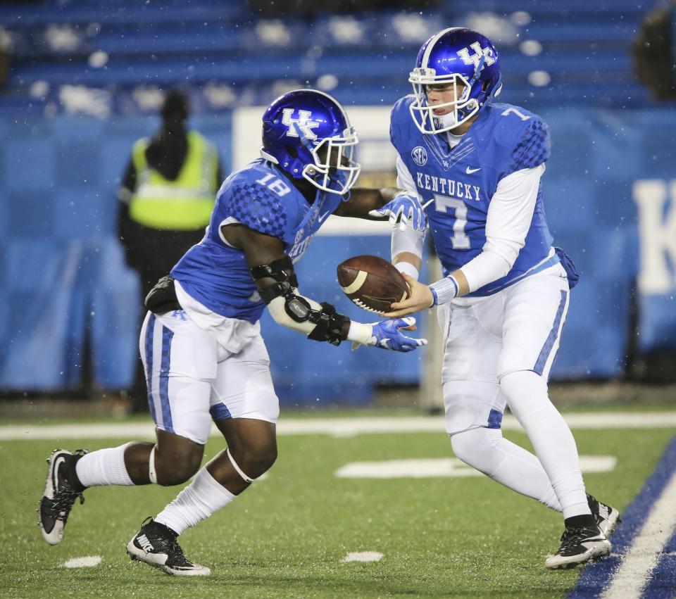 In this Nov. 21, 2015, file photo, Kentucky quarterback Drew Barker hands off the ball to running back Stanley Williams during the second half of an NCAA college football game against Charlotte in Lexington, Ky. (AP Photo/David Stephenson, File)