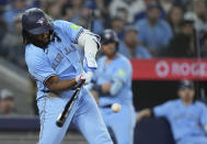 Toronto Blue Jays' Vladimir Guerrero Jr. hits an RBI double against the Kansas City Royals during sixth-inning baseball game action in Toronto, Monday, April 29, 2024. (Nathan Denette/The Canadian Press via AP)