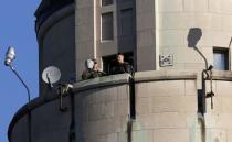 Police spotters keep watch from a high vantage point during Remembrance Day ceremonies at the National War Memorial in Ottawa November 11, 2014. REUTERS/Chris Wattie
