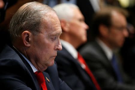 U.S. National Economic Council Director Larry Kudlow listens to U.S. President Donald Trump speak about his summit with Russia's President Vladimir Putin as Kudlow sits beside Vice President Mike Pence during a meeting with members of the U.S. Congress at the White House in Washington, July 17, 2018. REUTERS/Leah Millis