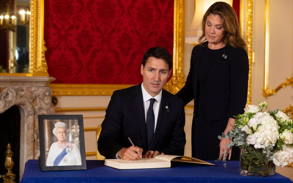 Justin Trudeau, prime minister of Canada, and his wife Sophie Trudeau sign a book of condolence at Lancaster House - David Parry/AFP via Getty Images