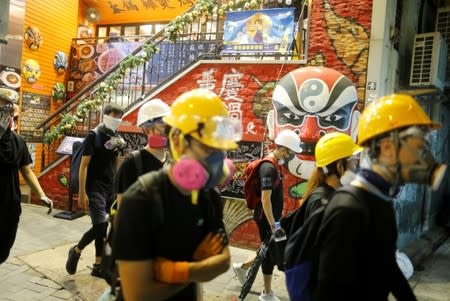 Anti-extradition bill protesters walk through Tsim Sha Tsui neighborhood in Hong Kong