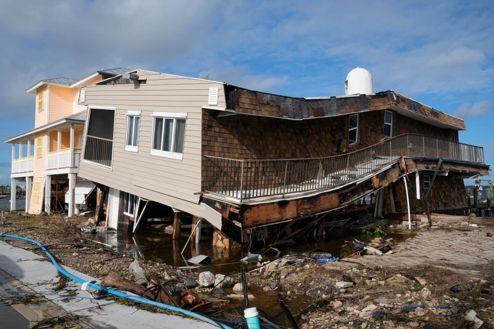 Houses lie ruined Thursday morning following devastation from Hurricane Milton in Matlacha, Florida. ((AP Photo/Marta Lavandier))